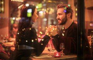 Young couple looking into each other's eyes over a table