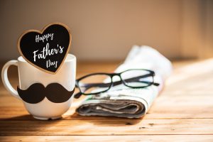 Happy fathers day mug and newspaper with glasses on top